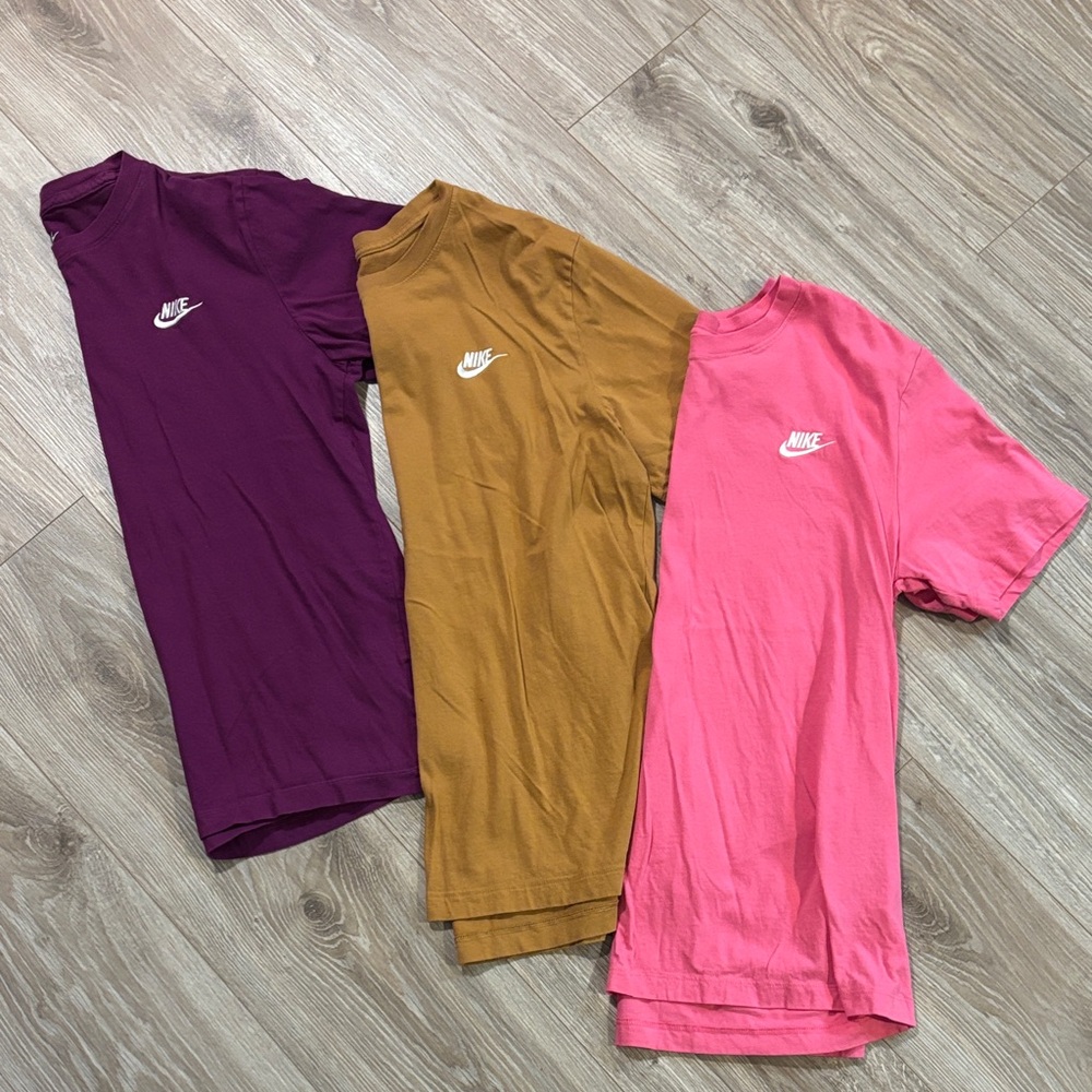 Lot of 3 Nike T-Shirts. Men’s medium. Solid colors. Purple, Camel, and Pink